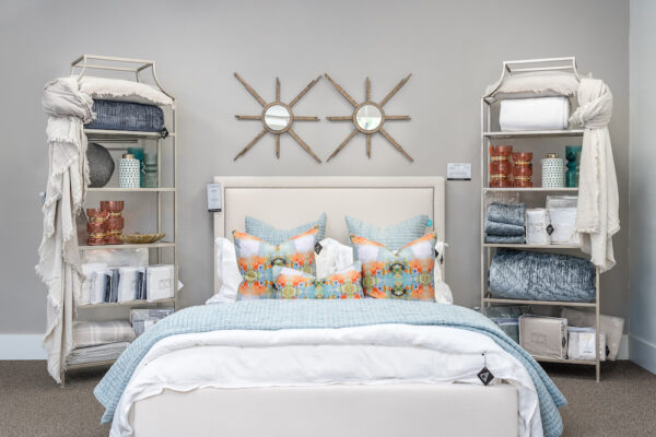 A bedroom interior design is highlighted with a high-end Bernhardt bed, Orchid Bedding, and Gabby mirrors.