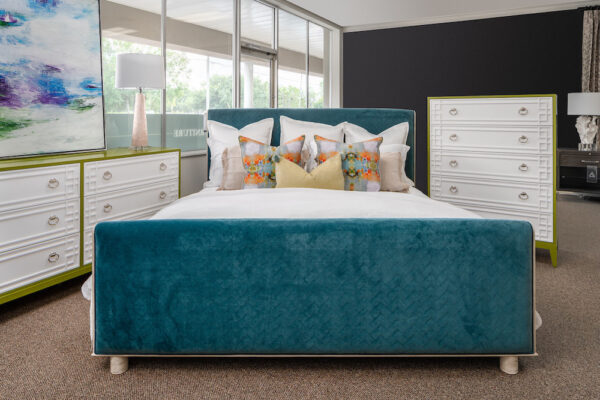A bedroom furniture set includes an Ambella bed, and a Century dresser that is flanked with Port 68 lamps.