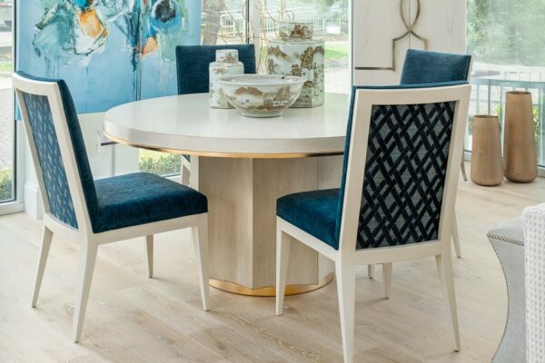 Blue Ambella chairs highlight this high-end dining set that is accompanied by an Ambella dining table and bar cabinet.
