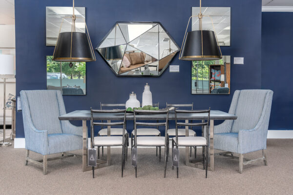 Interior designers created a dining room with Uttermost mirrors that coordinate with Gabby Home dining chairs.