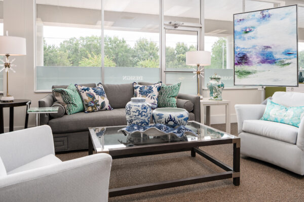 A Taylor King living room sofa is coordinated with a Hancock & Moore side table, and a Theodore Alexander coffee table.