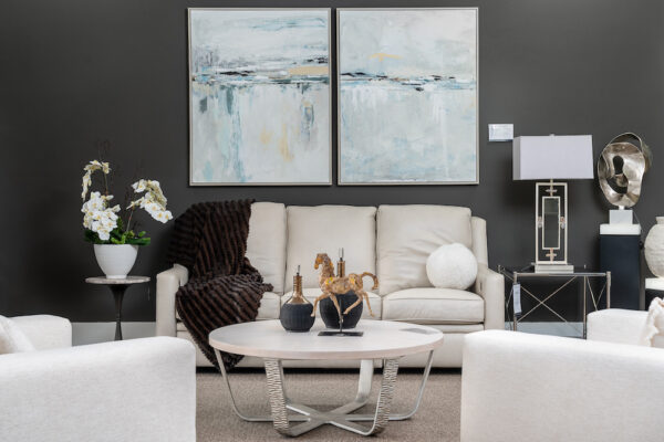 A living room’s décor & accessories includes Lux Art Silks botanicals, Wendover Art, Uttermost sculpture and Arnov vases.