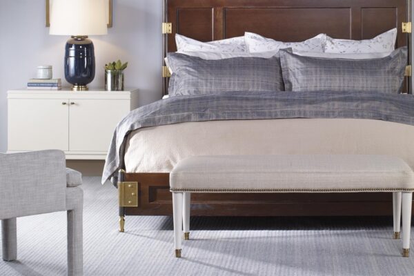 Solid wood bed frame with gold hardware by Century Furniture.